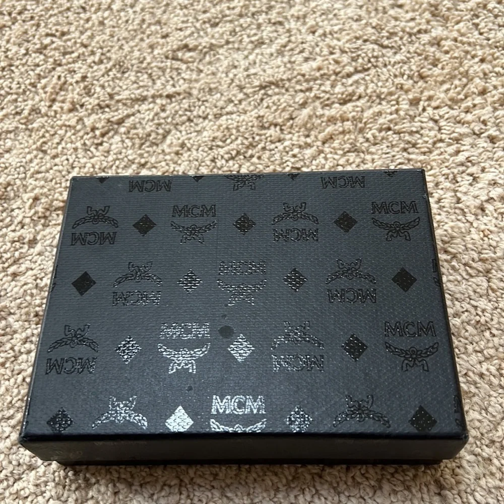 MCM men's lion embossed black with blue and grey mini zipped coin card holder